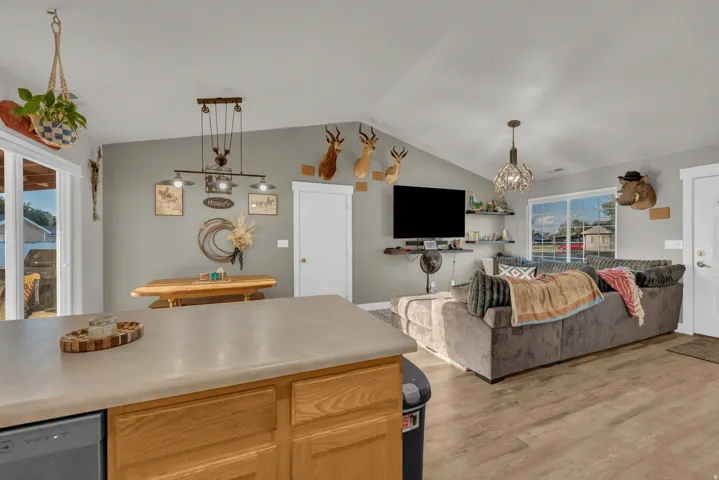 Vaulted ceilings, wood-finish flooring, and slider access to the outdoors
