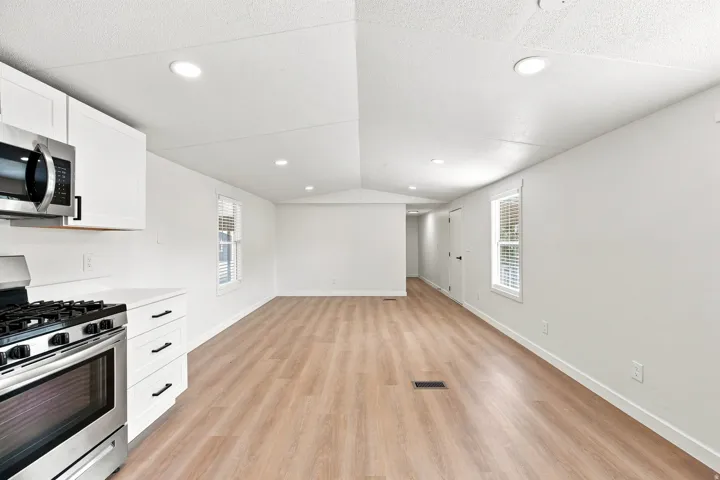 Well-lit interior featuring recessed lighting and wood-finish flooring