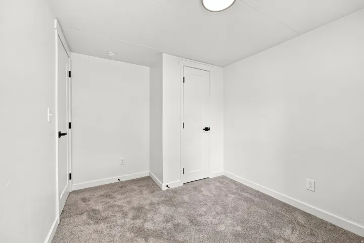 Plush carpeting and white wall finishes