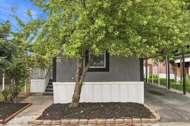 Exterior featuring a gray stucco finish and white horizontal siding