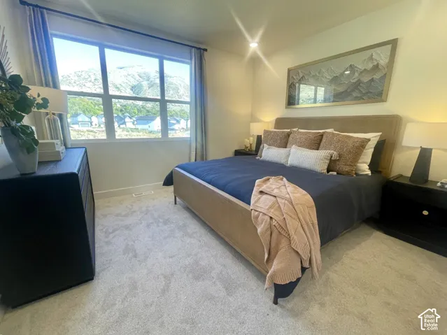 Model home photo of the primary bedroom of the same floor plan.