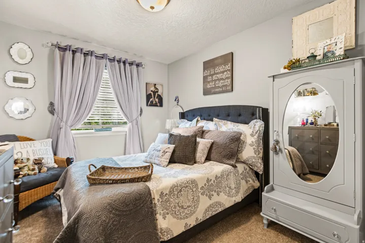 Wall-to-wall carpeting and a window with horizontal blinds