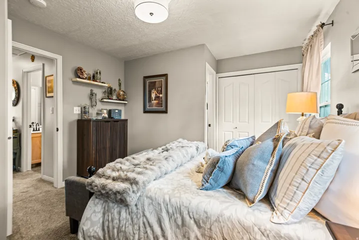 Neutral wall color, white ceiling, flush mount ceiling lighting, white bi-fold closet doors, and wood-finish cabinetry