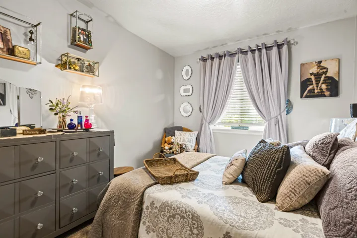 Wall-mounted shelving, window with blinds, and neutral wall tones