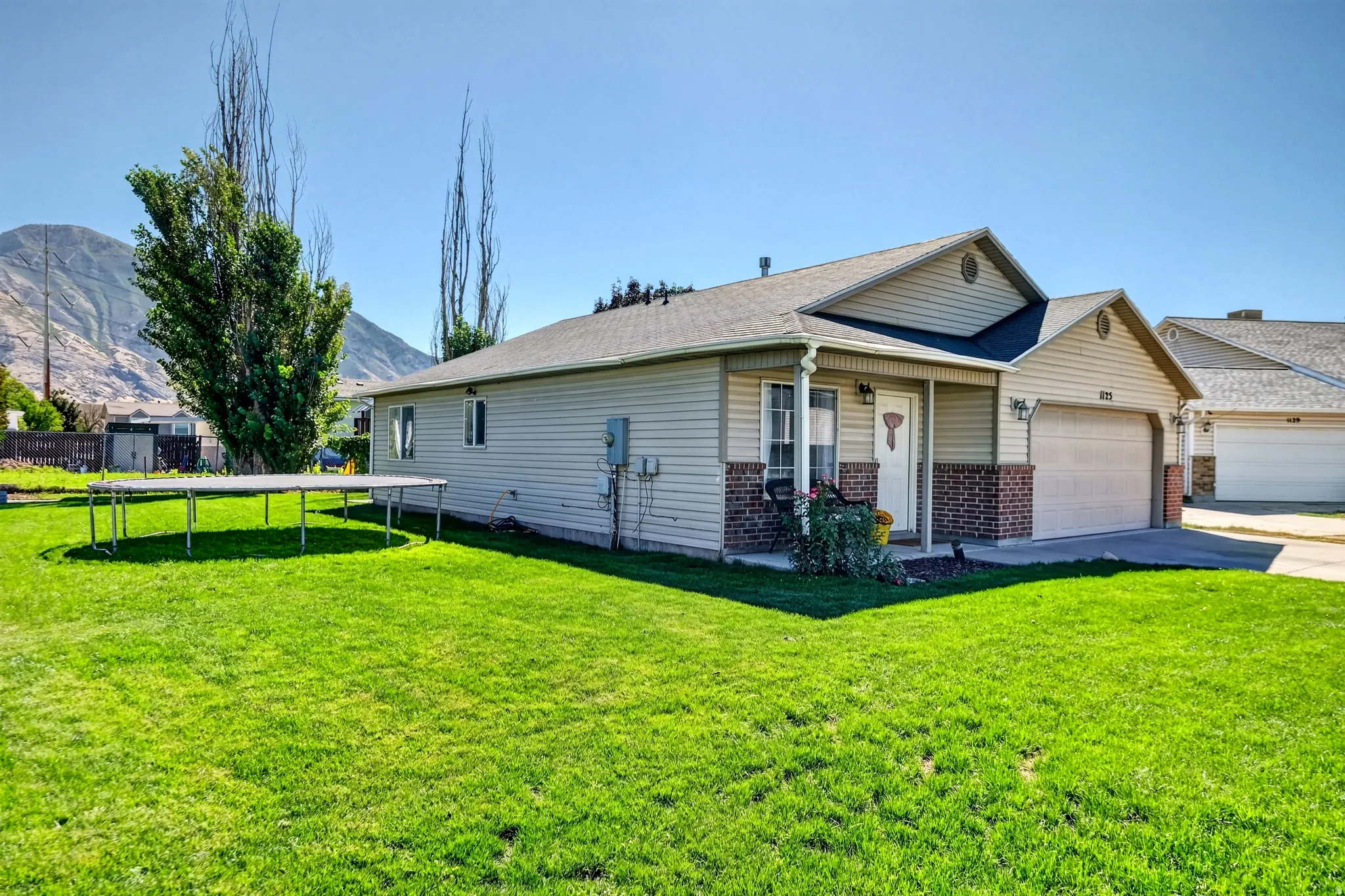 Ranch-style exterior with vinyl siding and brick accents