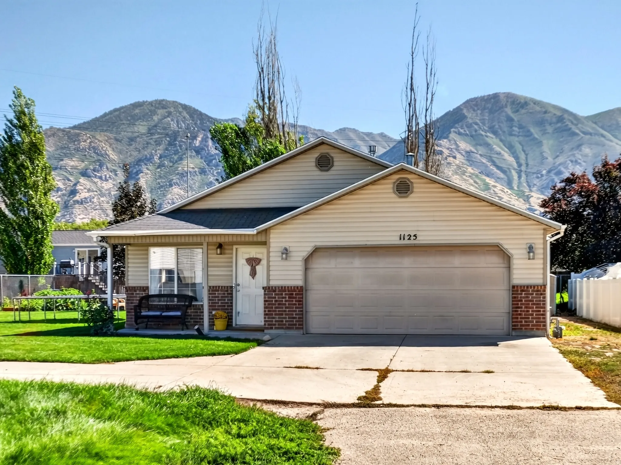 Exterior featuring a covered porch, attached garage, and a concrete driveway