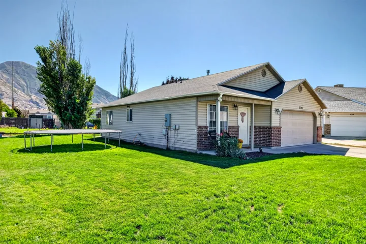 Ranch-style exterior with vinyl siding and brick accents