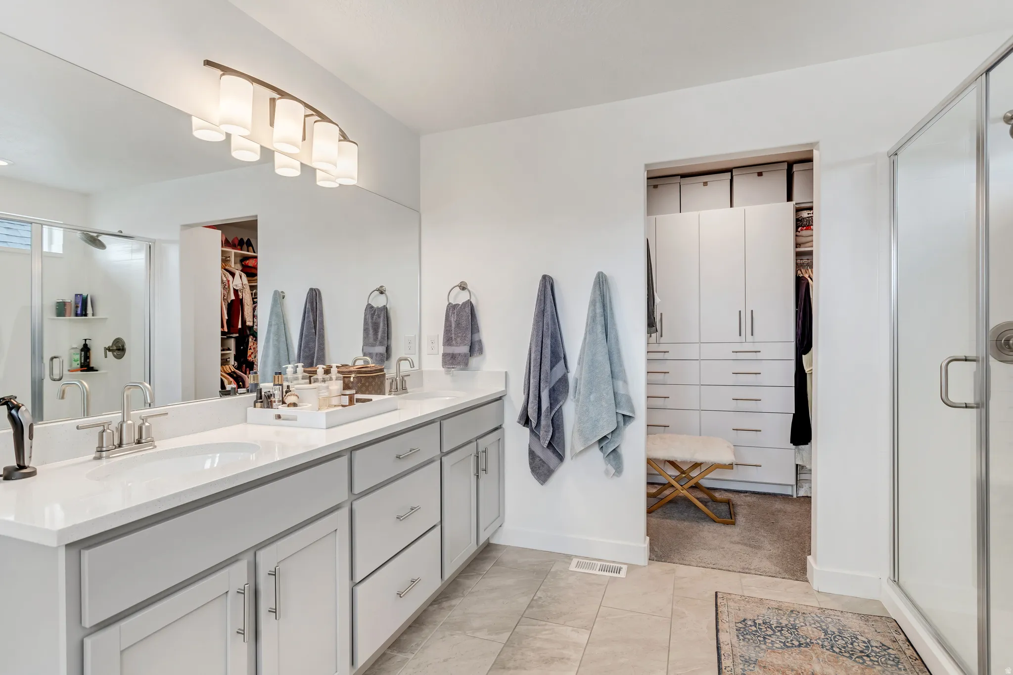 Dual vanity with white countertops and undermount sinks