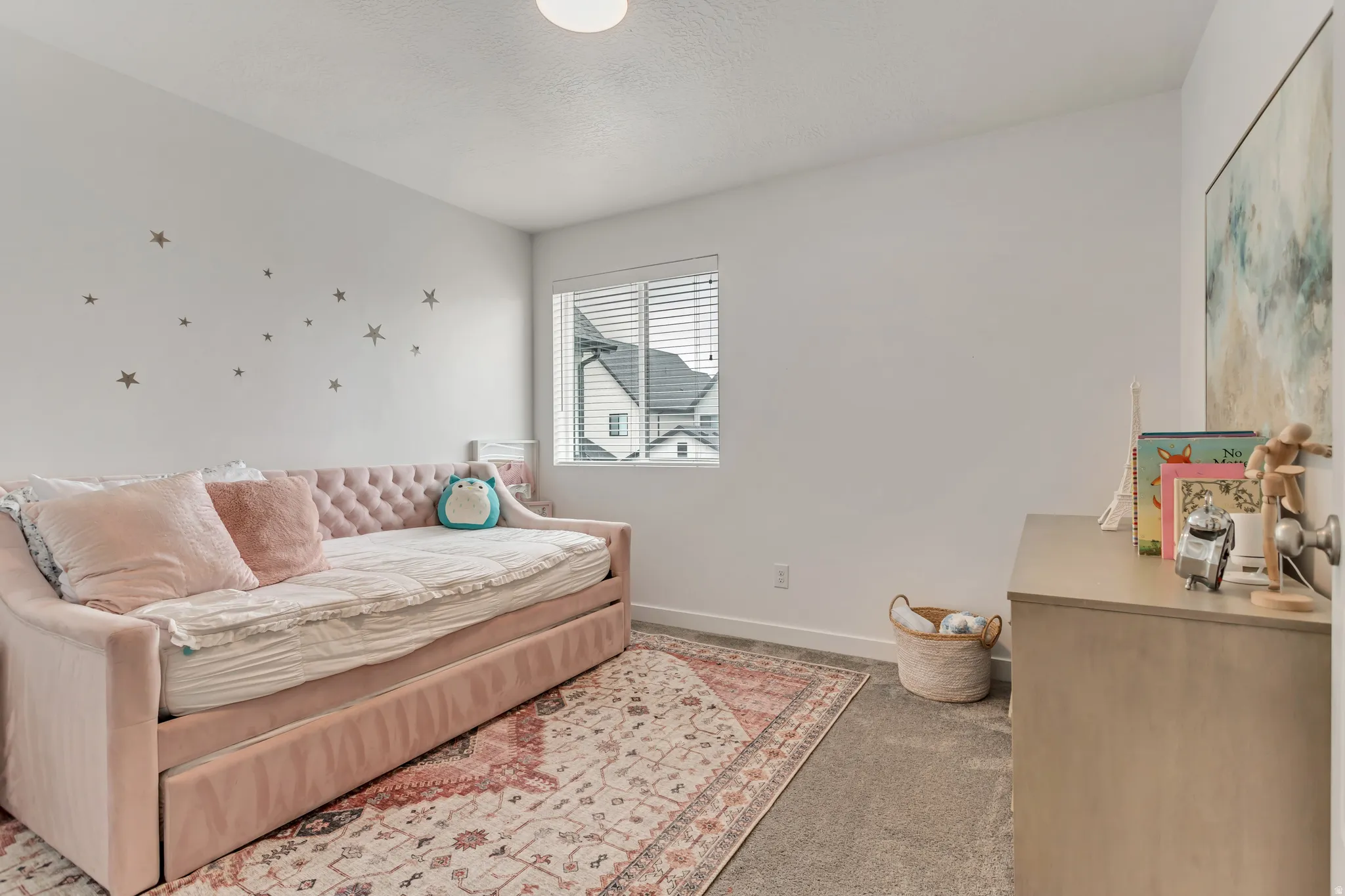 Wall-to-wall carpeting, window with blinds, and white painted walls