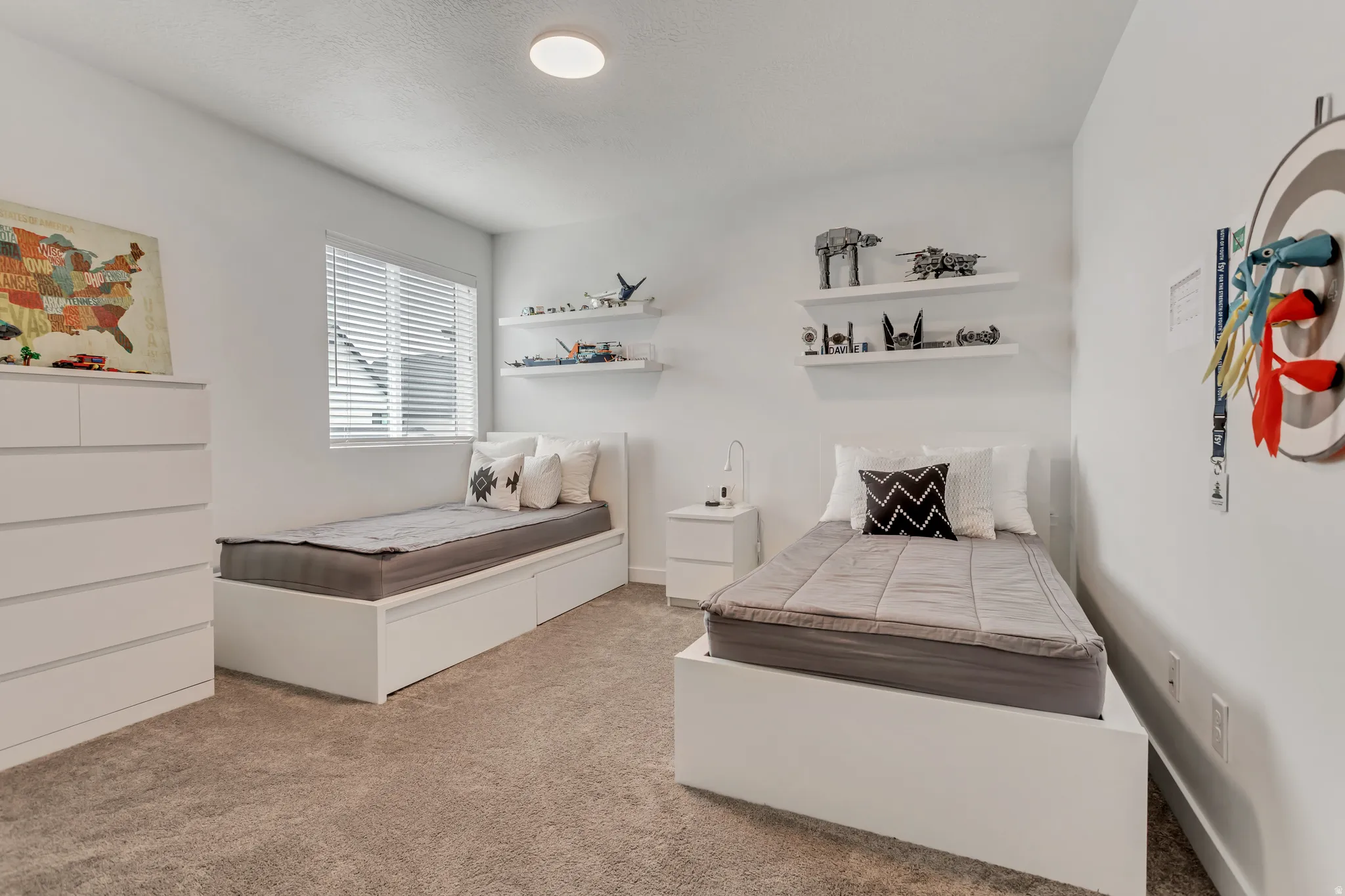 White walls with recessed lighting and a window featuring horizontal blinds