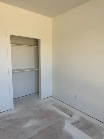 Recessed closet with a single shelf and hanging rod
