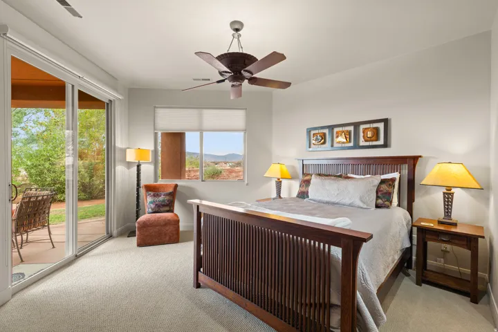 Interior space featuring carpet flooring, a ceiling fan, and sliding glass doors