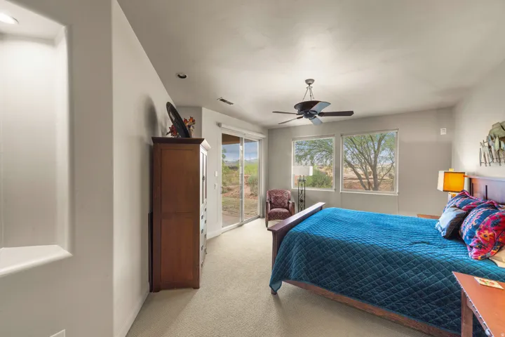 Recessed ceiling light, ceiling fan, carpeting, dual windows, and glass sliding door