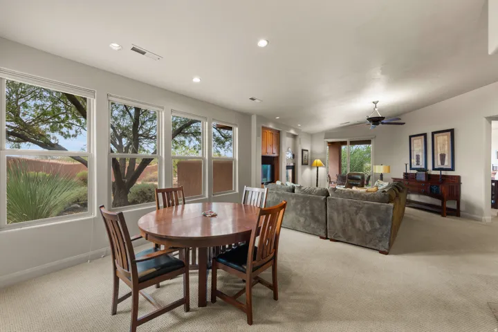 Open-concept living space with multiple windows, recessed lighting, and a ceiling fan