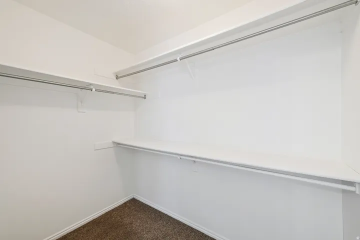 Wall-mounted shelving system with integrated hanging rods, providing ample storage