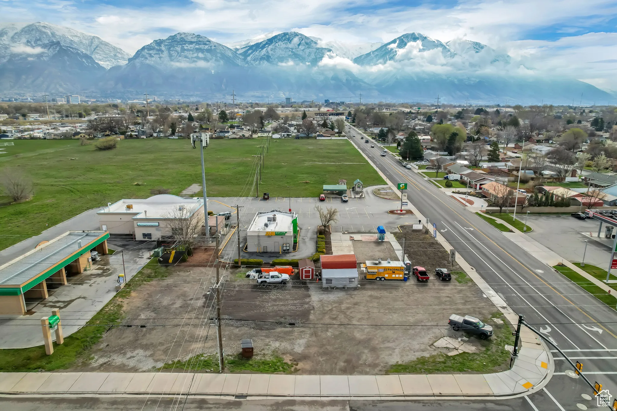 Expansive undeveloped land parcels with mountain backdrop