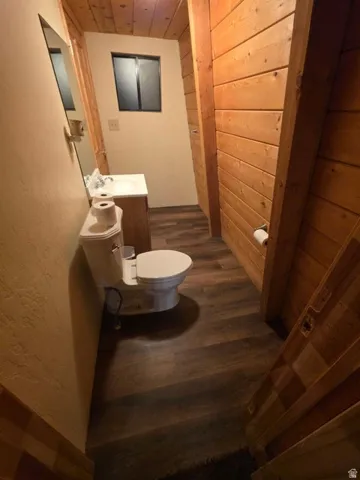 Wood-finish flooring, wood plank walls, and a wood plank ceiling