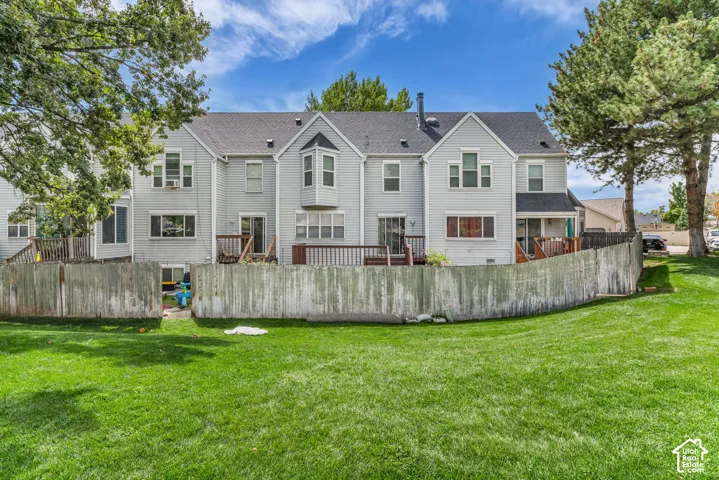 Expansive green lawn with a wooden fence