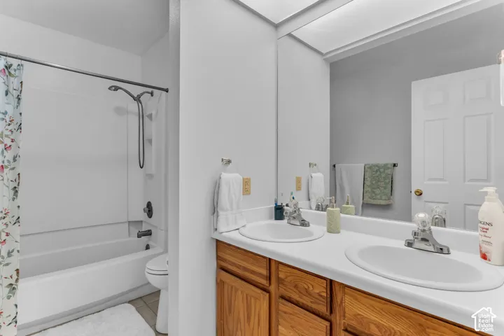 Dual vanity with white countertop and wood-finish cabinetry