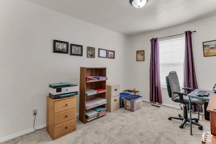 Window with blinds, wall-to-wall carpeting, and overhead light fixture