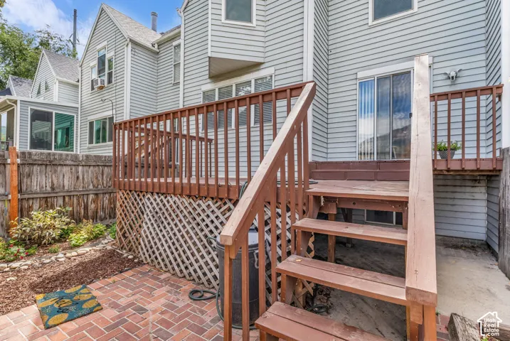 Brick paver patio with a wood privacy fence