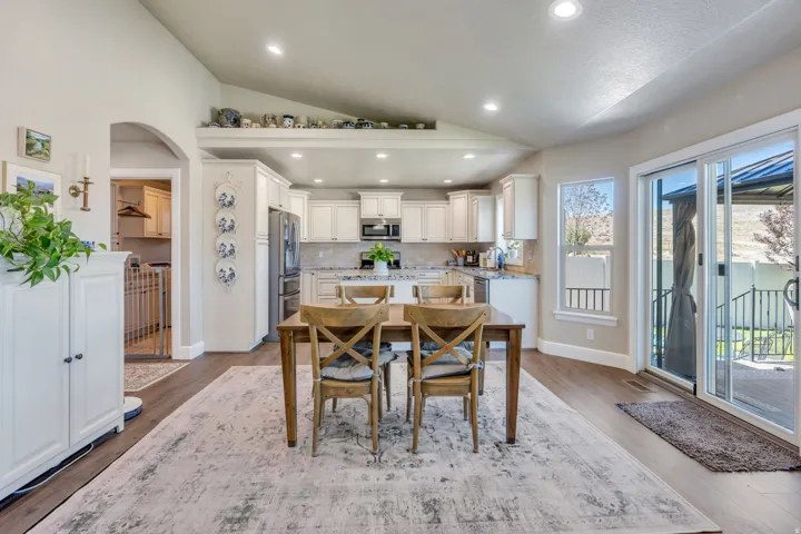 Vaulted ceilings, recessed lighting, and wood-finish flooring
