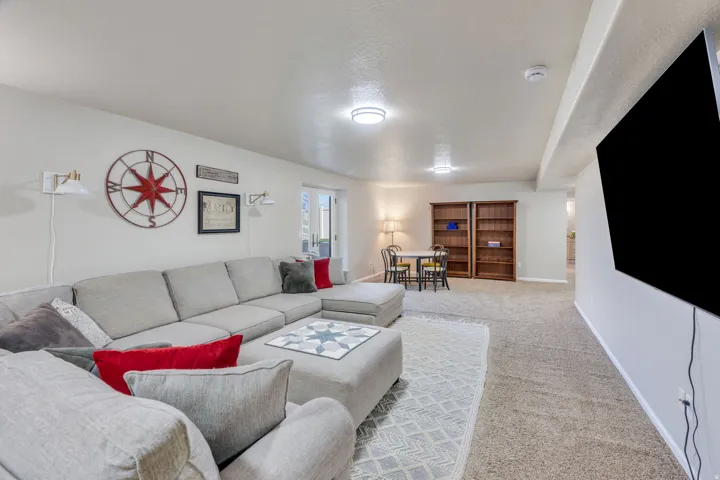 Recessed lighting, wall-mounted television, and carpet flooring