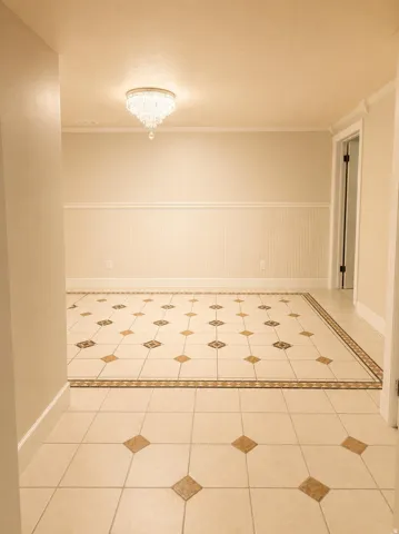 Recessed lighting, wainscoting, crown molding, and decorative tile flooring