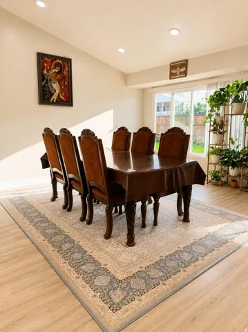 Recessed ceiling lighting, light wood-finish flooring, and large sliding glass doors