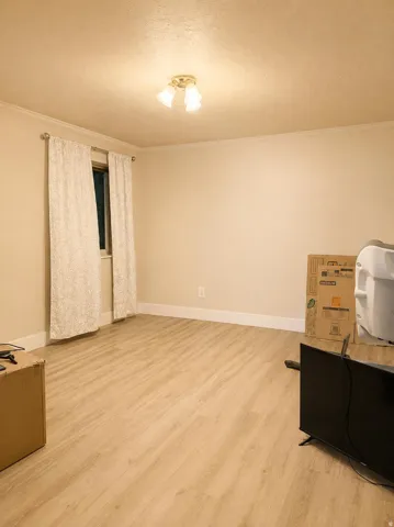 Wood-finish flooring with white trim and a neutral color palette