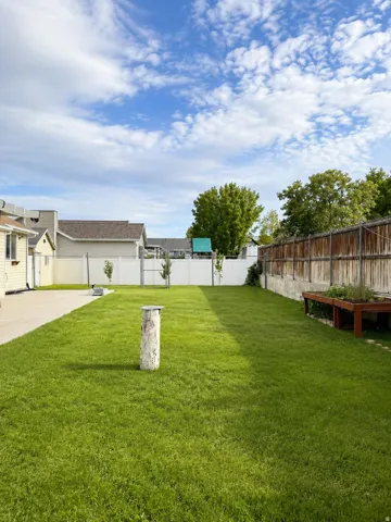 Expansive lawn area with a concrete patio