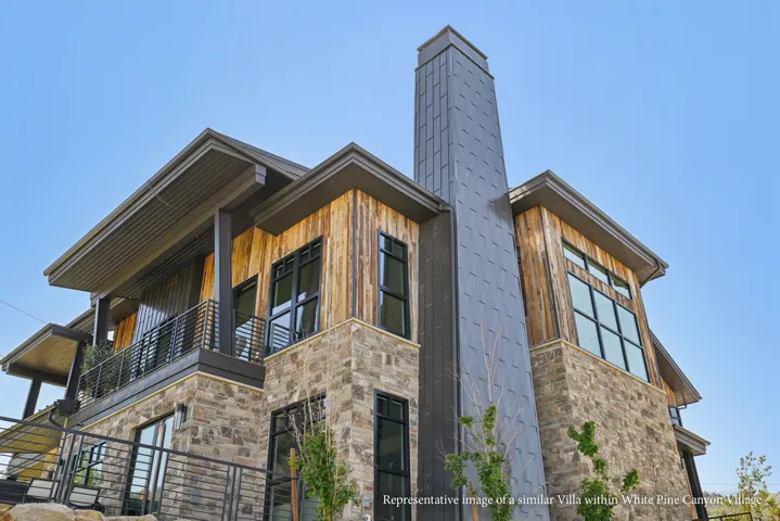 Stone and wood-finish exterior with a metal chimney