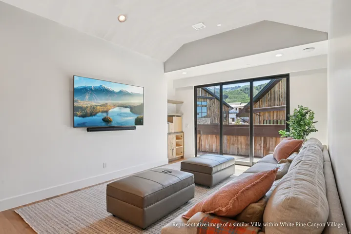 Vaulted ceilings, recessed lighting, wood-finish flooring, built-in shelving, and a glass sliding door