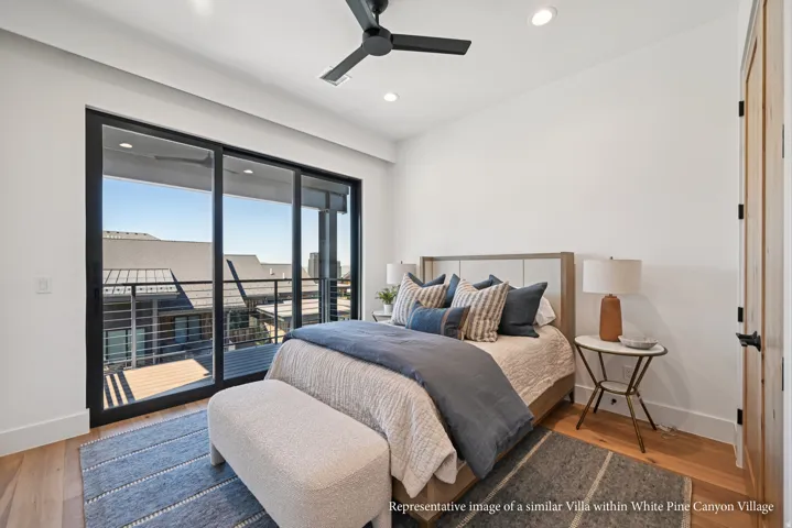 Sliding glass door leading to an exterior balcony with cable railings, wood-finish flooring, a ceiling fan, and recessed lighting