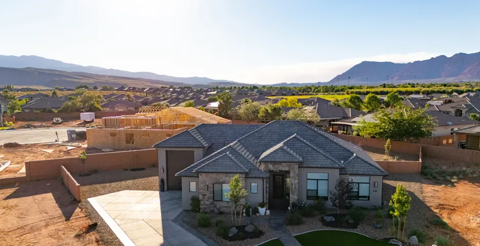 Stone and stucco exterior with an attached two-car garage