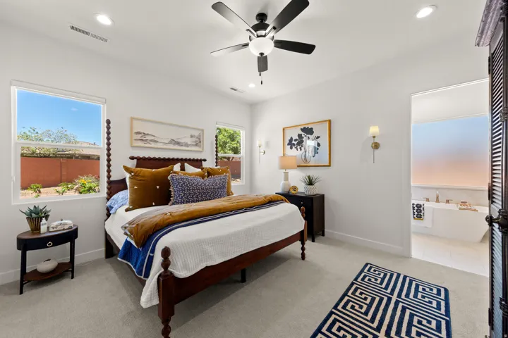 Recessed lighting, ceiling fan with integrated light, multiple windows, wall sconces, built-in bathtub