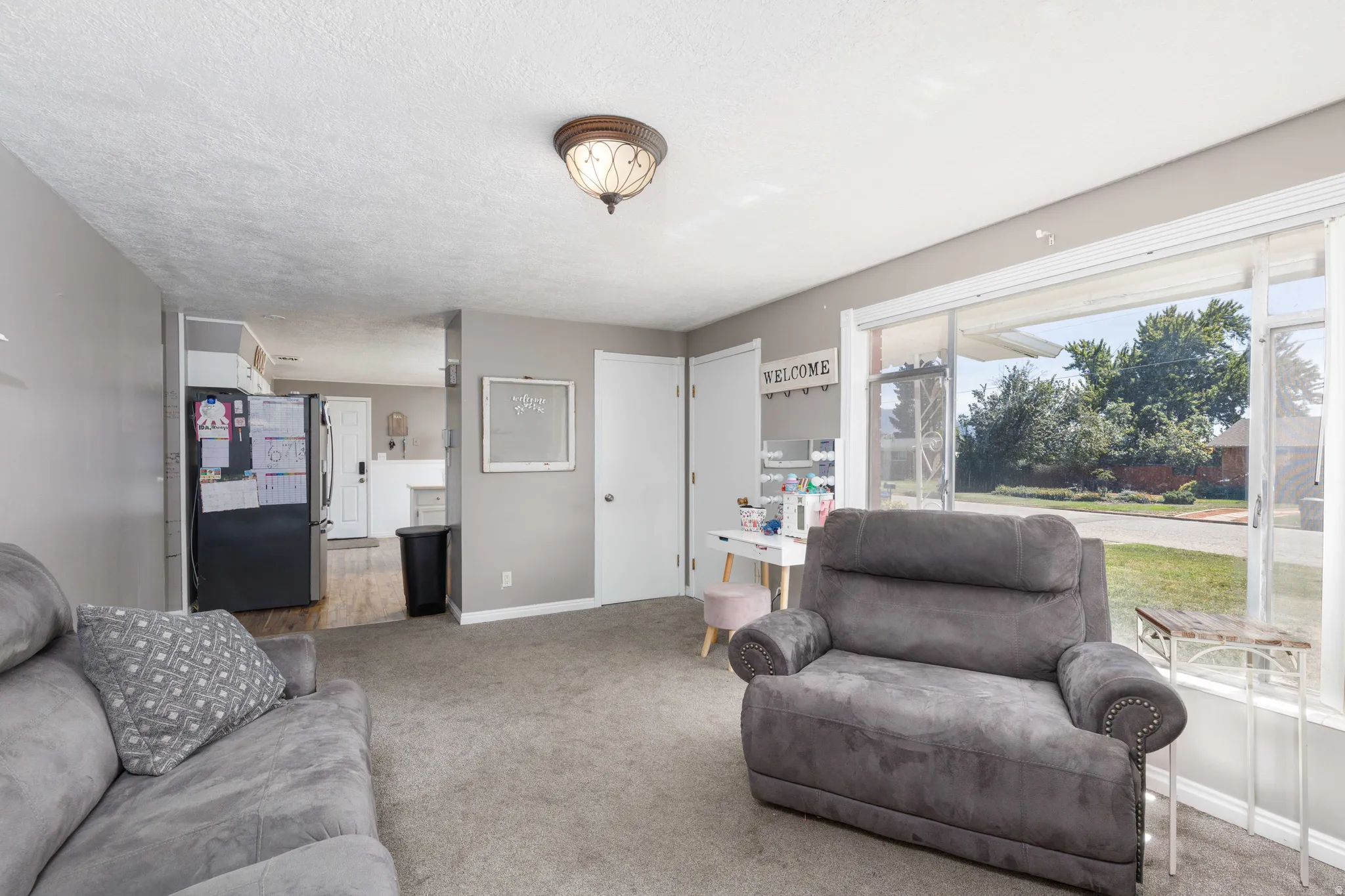 Wall-to-wall carpeting and a wide window with exterior views