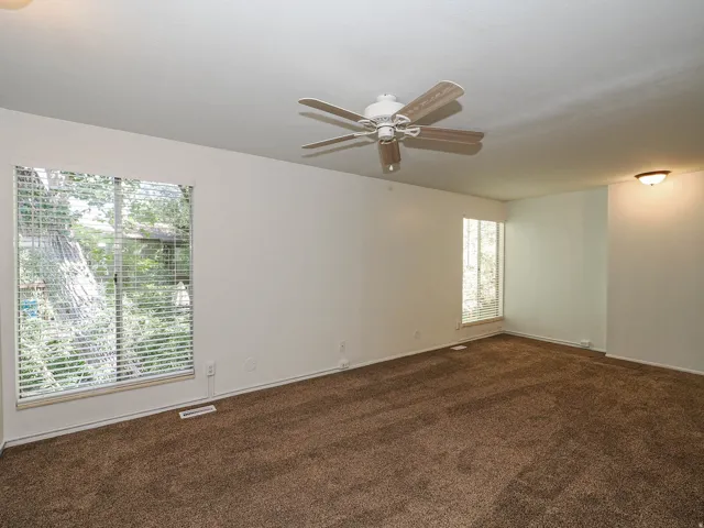 Plush carpet flooring, ceiling fan with integrated lighting, window blinds, and recessed ceiling light fixture
