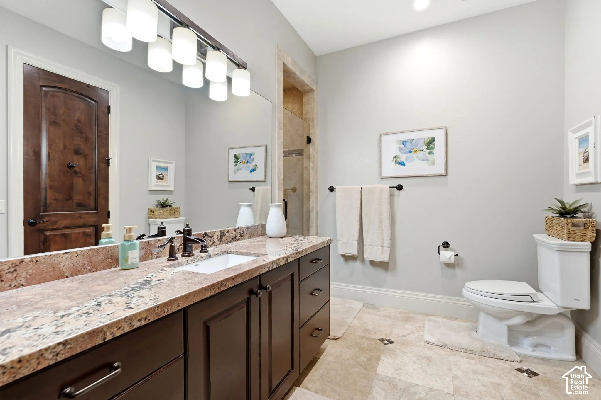 Vanity with a stone countertop, an integrated sink, and an oil-rubbed bronze faucet