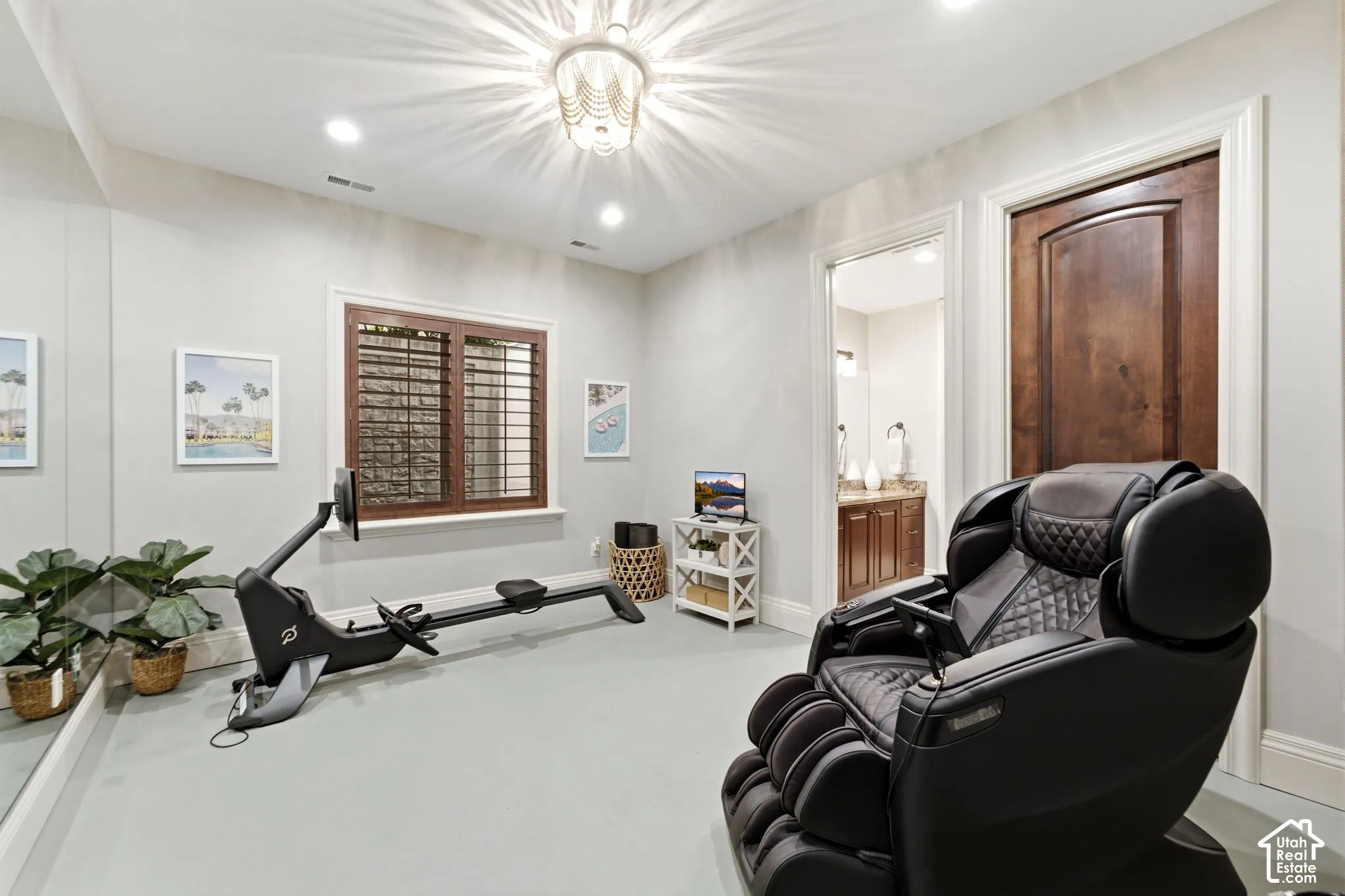 Recessed lighting, wood-finish interior door, plantation shutters, full-height wall mirror, and a decorative ceiling light fixture