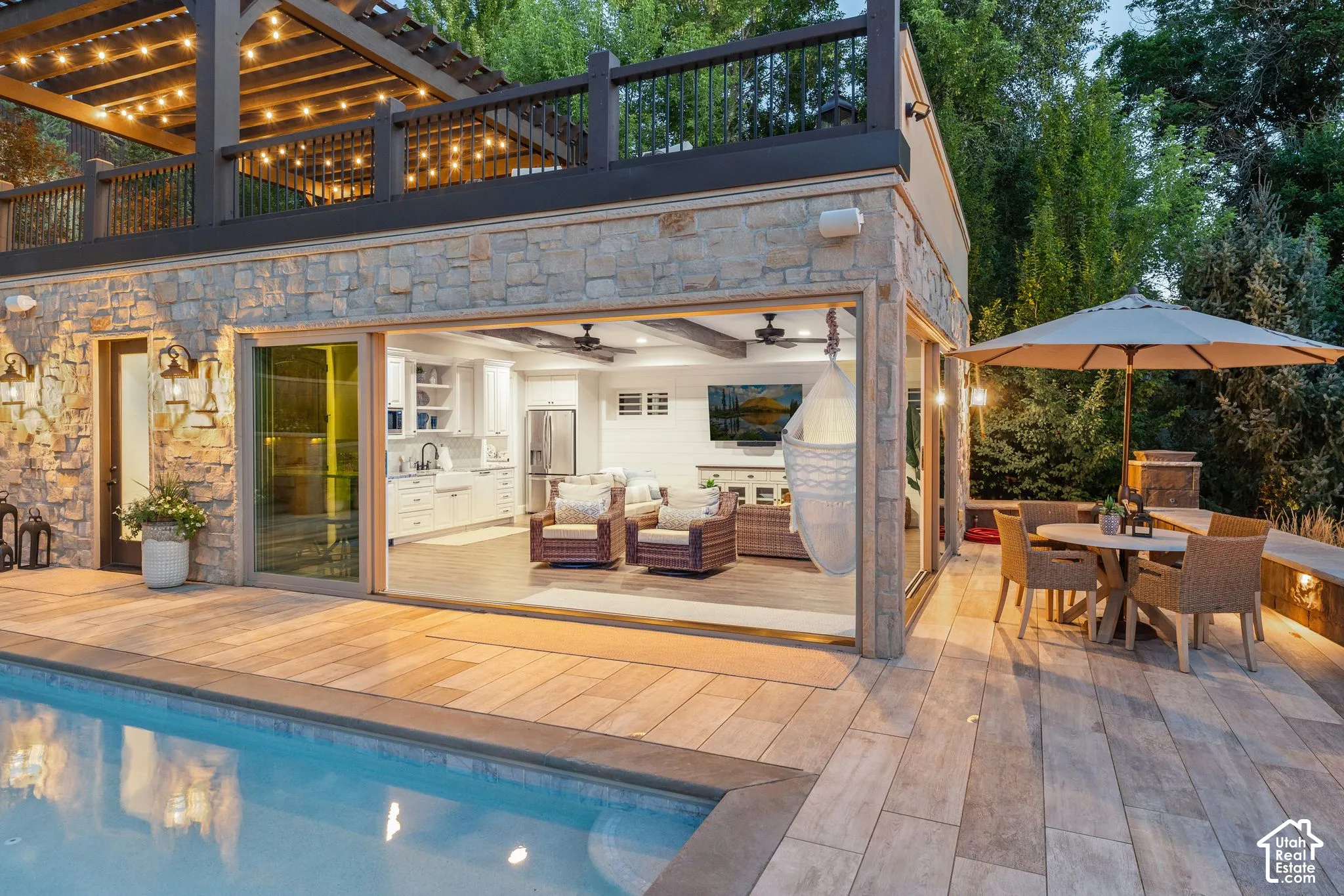 Casita Stone-clad exterior with a swimming pool, expansive patio, and an open-concept interior featuring a kitchen and living area