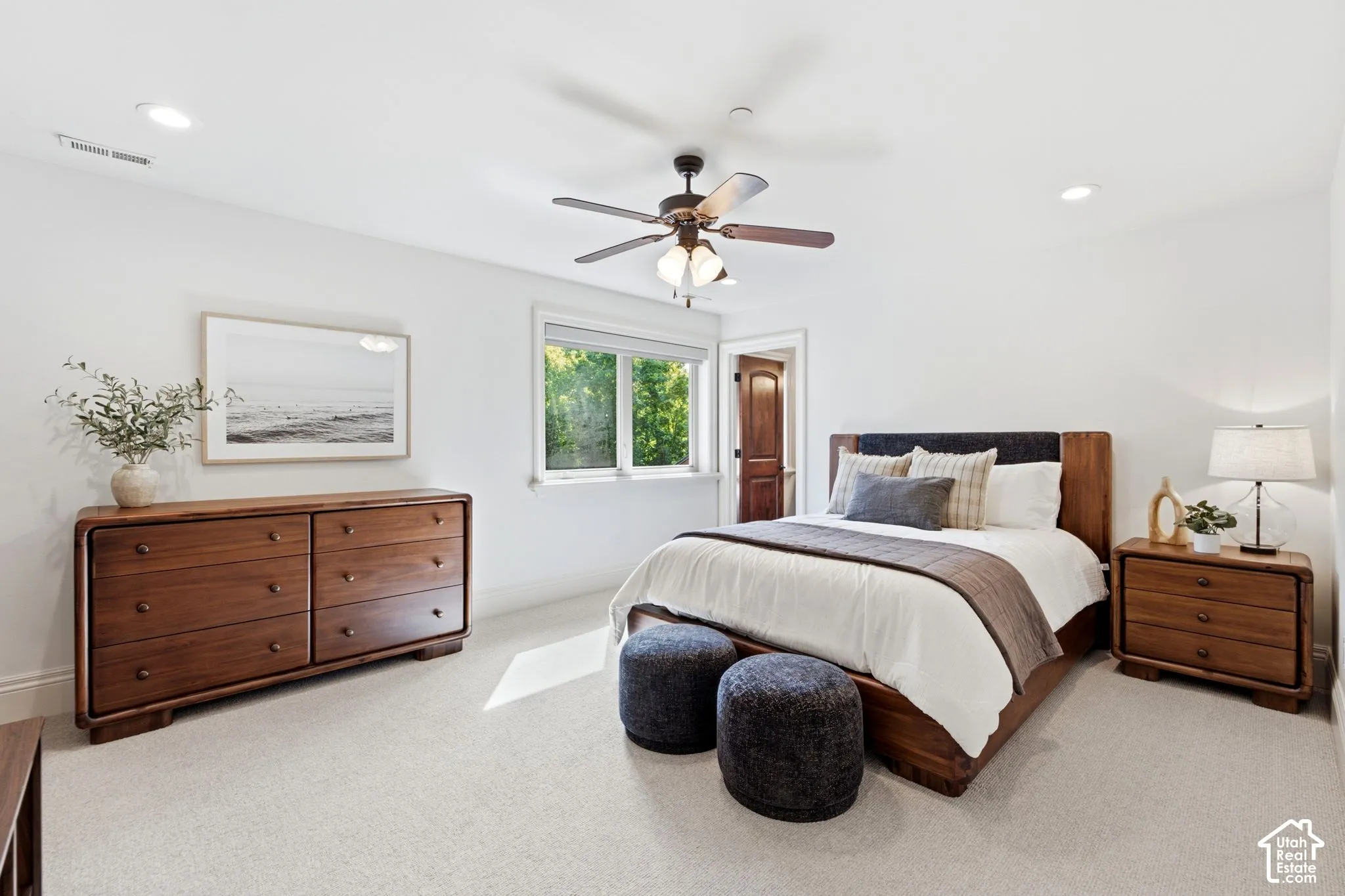 Recessed lighting, ceiling fan, carpeted flooring, window with natural light, and a wood-paneled door