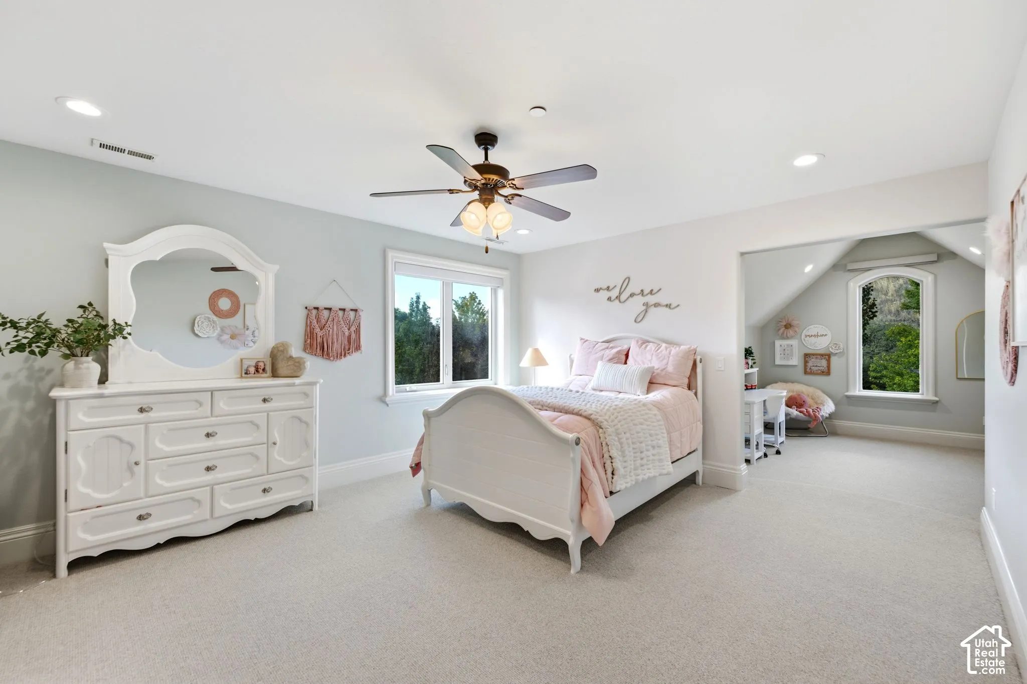 Recessed ceiling lighting, ceiling fan with integrated light, light-toned walls, and soft carpeting
