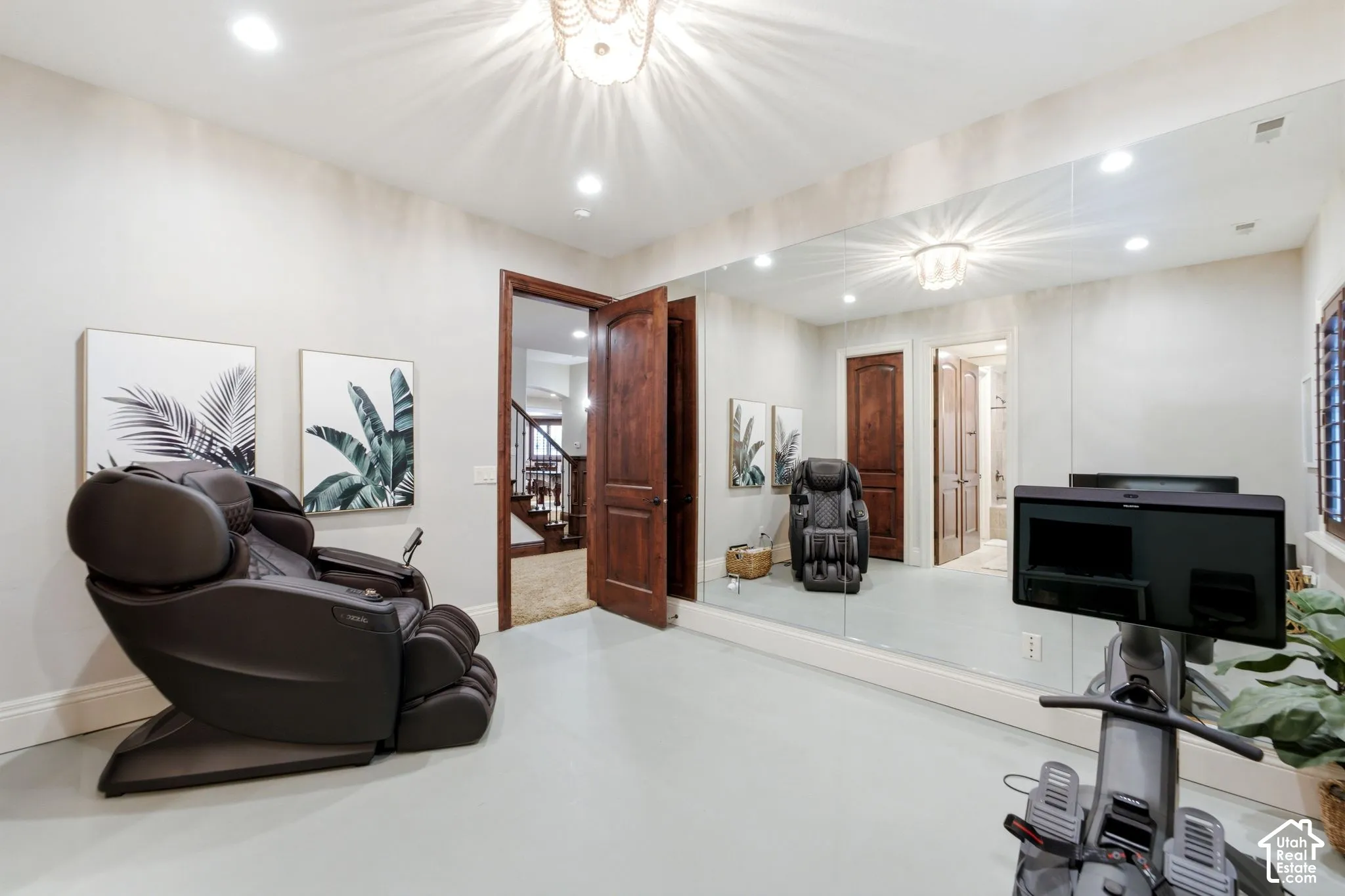 Integrated wall-to-wall mirror with recessed lighting and a decorative ceiling fixture