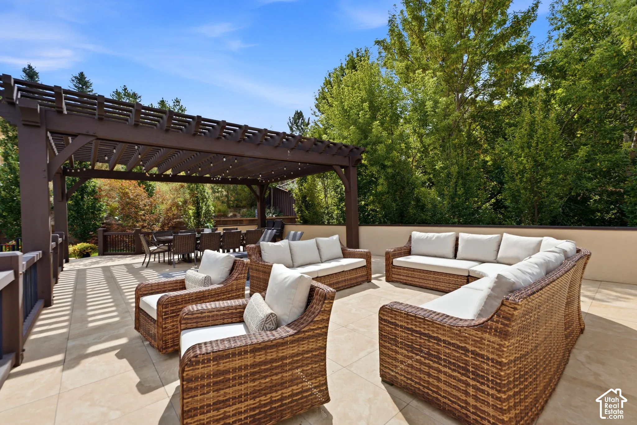 Roof Top Deck Expansive outdoor patio featuring a large pergola, hardscape flooring, and a low privacy wall