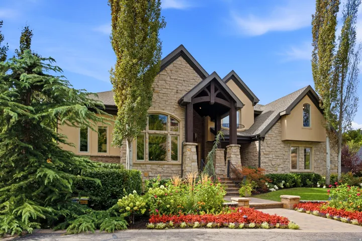 Stone and stucco exterior with a prominent arched entry