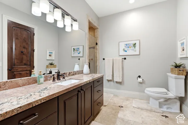 Vanity with a stone countertop, an integrated sink, and an oil-rubbed bronze faucet