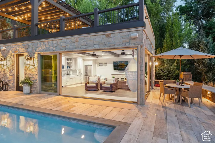 Casita Stone-clad exterior with a swimming pool, expansive patio, and an open-concept interior featuring a kitchen and living area