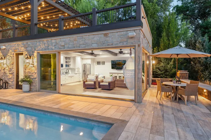 Casita Stone-clad exterior with a swimming pool, expansive patio, and an open-concept interior featuring a kitchen and living area
