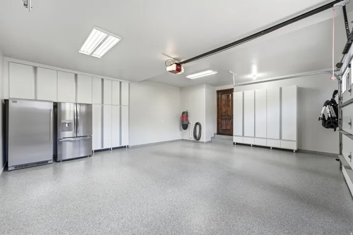 Epoxy-coated flooring, extensive built-in cabinetry, dual stainless steel refrigerators, and recessed lighting